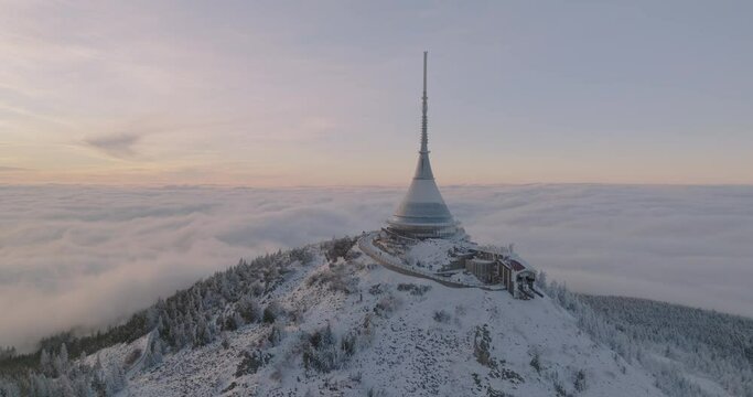 Jested tower mountain hill with snow mist and fog at golden hour