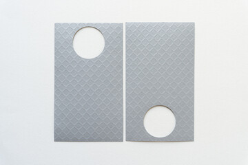 two gray-silver cards with circle cutouts