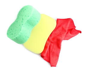 Sponges and car wash cloth on white background, top view