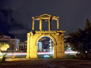 Fototapeta na wymiar Light trails behind Hadrian Arch at night, Athens, Greece