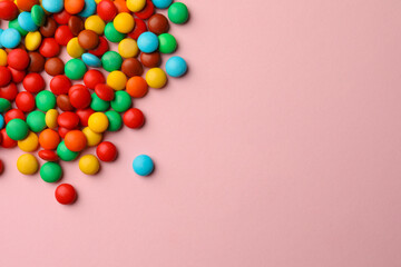 Tasty colorful candies on pink background, flat lay. Space for text