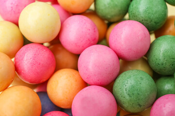 Many bright chewy gumballs as background, closeup