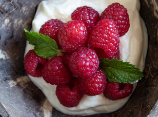raspberries in a bowl with cream
