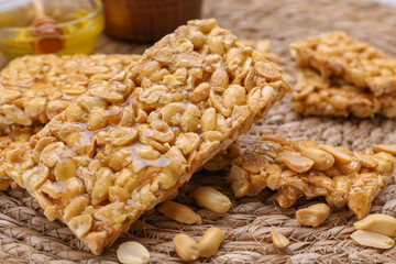 Delicious peanut bars (kozinaki) on wicker mat, closeup