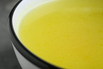 Bowl of delicious chicken bouillon, closeup view