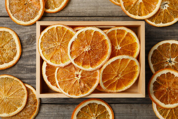 Fototapeta na wymiar Dry orange slices on wooden table, flat lay