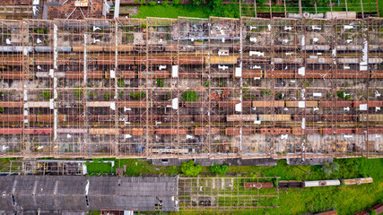 abandoned train station and wagon, with forest covering part of them. Aerial view on the city of Sorocaba, Brazil