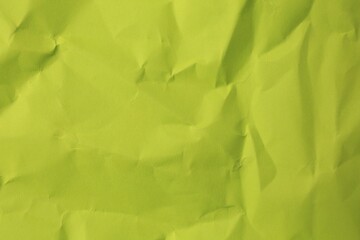 Sheet of crumpled light green paper as background, top view