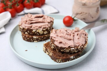 Fototapeta na wymiar Delicious liverwurst sandwiches served on white table, closeup