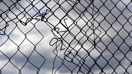 broken mesh grid against sky