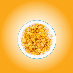 Bowl of sweet cornflakes with milk on orange background, top view. Corn flakes with milk splashes on orange