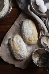 Raw dough, eggs and flour on wooden table, flat lay. Cooking ciabatta