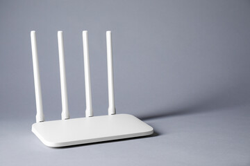 New stylish Wi-Fi router on grey background. Space for text
