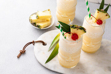 Tropical pina colada cocktail or mocktail in a tiki glass