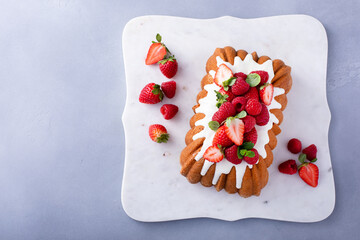 Traditional pound cake topped with glaze and fresh berries