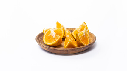 Fototapeta na wymiar orange slices in a bowl on a white background. The photo is out of focus, blurred, and noisy.