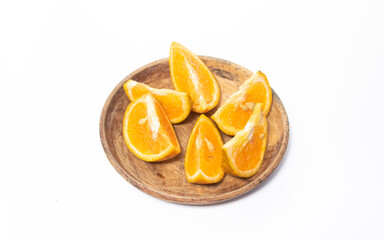 Naklejka na ściany i meble orange slices in a bowl on a white background. The photo is out of focus, blurred, and noisy.
