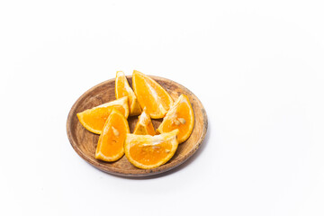  orange slices in a bowl on a white background. The photo is out of focus, blurred, and noisy.