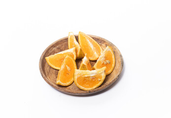  orange slices in a bowl on a white background. The photo is out of focus, blurred, and noisy.