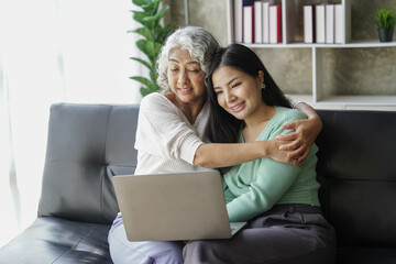 Candid attractive beautiful mum sit at cozy sofa couch living room in family moment grown child kid celebrate joy good warm time kiss relationship with retired overjoy lady girl health life.