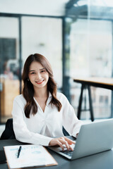 Fototapeta premium Portrait of a business woman working on a computer at work