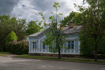 An old wooden traditional Russian residential building, an architectural monument, on the street of Gatchina on a summer day, Leningrad region, Russia