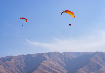 Active sport, paraglider and people in the sky. Instructor and passenger on a paraglider.