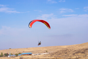 Active sport, paraglider and people in the sky. Instructor and passenger on a paraglider.