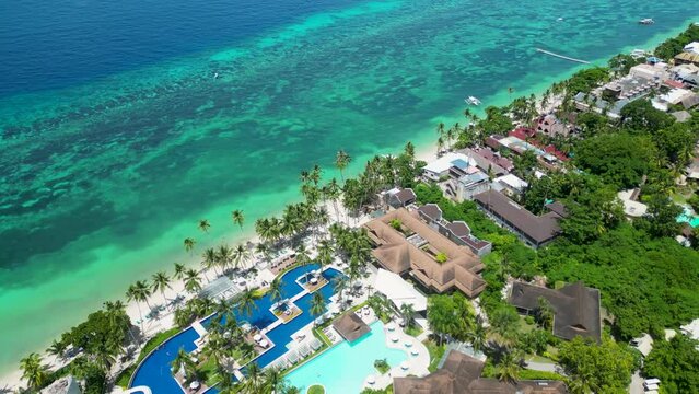 Luxury coastal homes, pools on tropical island of Bohol in Philippines. Emerald southern sea, washing shore of island, on which there are chic apartments for tourists. Tourist paradise for travelers.