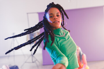 Image of happy afican american female hip hop dancer in studio