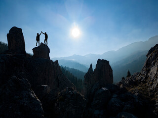 activity of successful couples together and mystical landscapes of enormous mountains