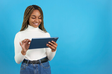 Smiling african woman using a digital tablet
