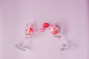 two wine glasses on a pink background with confetti inside