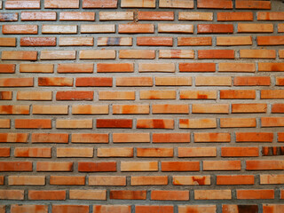 Orange bricks make become brick wall background.Old or ancient surface.Neatly arranged.View of copy space.