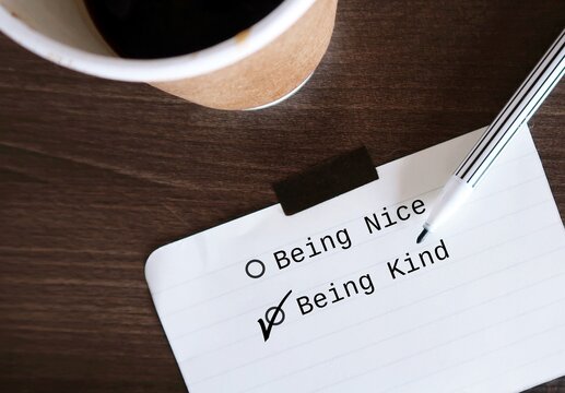 Note paper with check box BEING NICE and BEING KIND, and choose BEING KIND to stop being People Pleaser, prioritize self-respect and start being kind instead