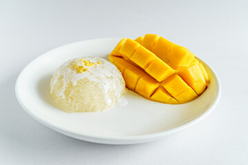 Fresh ripe mango and sticky rice with coconut milk. Traditional Thai dessert on white background.