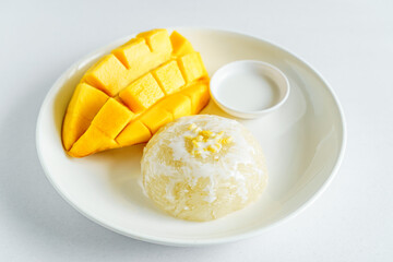 Fresh ripe mango and sticky rice with coconut milk. Traditional Thai dessert on white background.