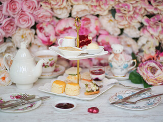 Happy Valentine's day. Rose afternoon tea with soft focus on the scones. Teapot and teacups on the side.