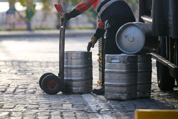 Man delivering beer kegs in Malaga, Spain