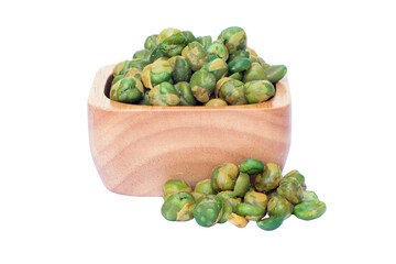 Green peas coated by salt from overflowing wooden cup. Isolated on cutout PNG. A snack crispy baked...