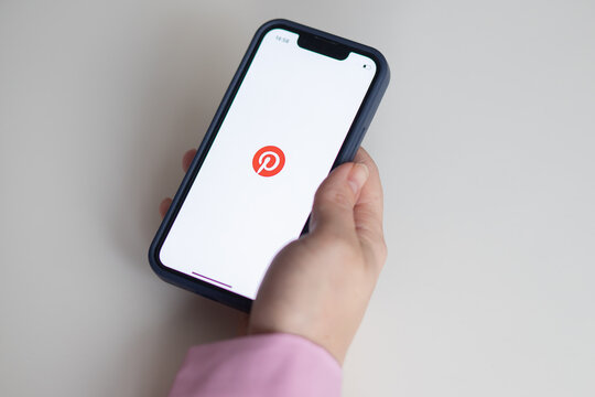 Pinterest app icon, Pinterest is Internet social network on the screen of the iphone in female hand, Georgia, Batumi, December 6, 2022