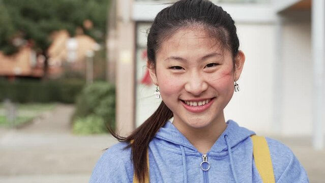 Chinese female teenager Student Smiling looking to the camera. Portrait of Asian Young Woman