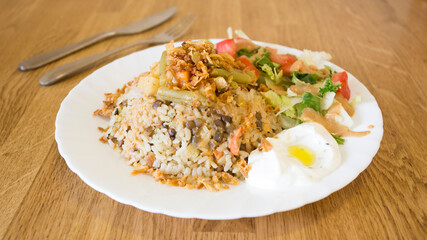 African combo plate with rice, fried cheese, grilled vegetables, peanut sauce and other traditional products.