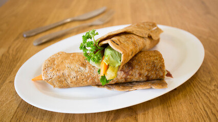 Goraasa roll with vegetables. Goraasa is a Sudanese pancake or flatbread that is fluffy, versatile, soft and doughy.