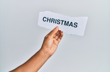 Hand of caucasian man holding paper with christmas word over isolated white background