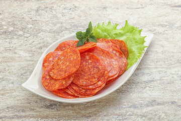 Sliced pepperoni sausage in the bowl