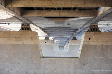 The lower abutments of the gray bridge are directed towards the perspective