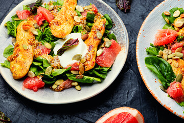 Fresh salad with chicken breast, herbs and fruits
