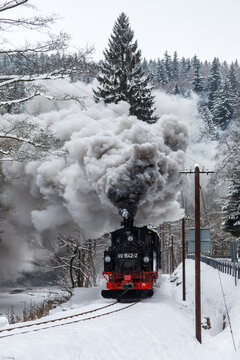 Pressnitztalbahn steam train locomotive railway in winter portrait format in Jöhstadt, Germany