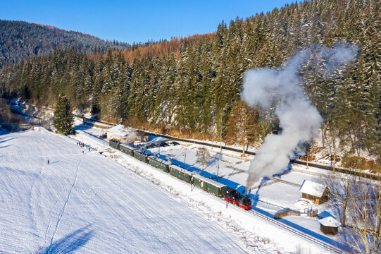 Pressnitztalbahn steam train locomotive railway aerial view in winter in Schmalzgrube, Germany
